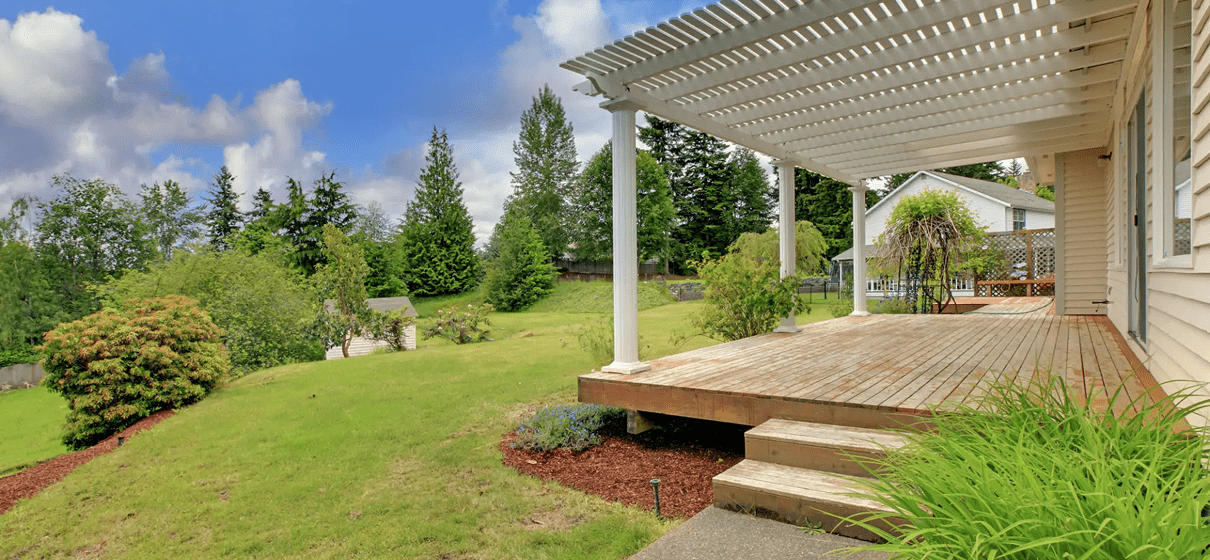 Backyard with wooden deck and greenery